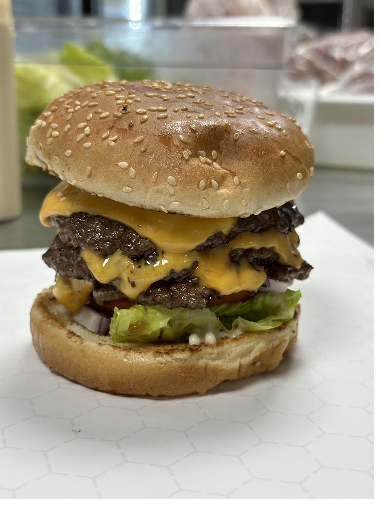 Double cheeseburger with melted cheddar and fresh toppings